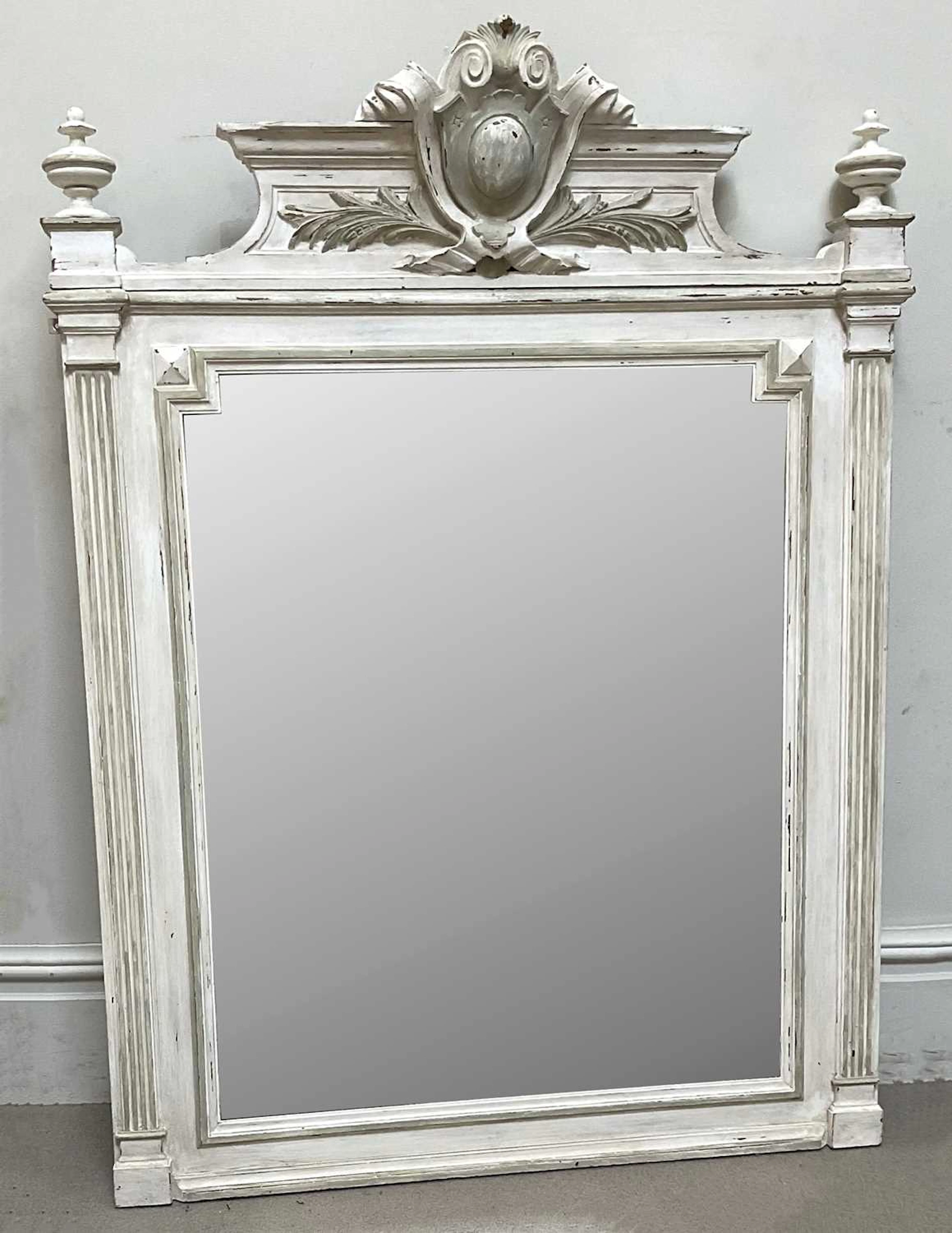 A decorative Victorian French white painted wall mirror
