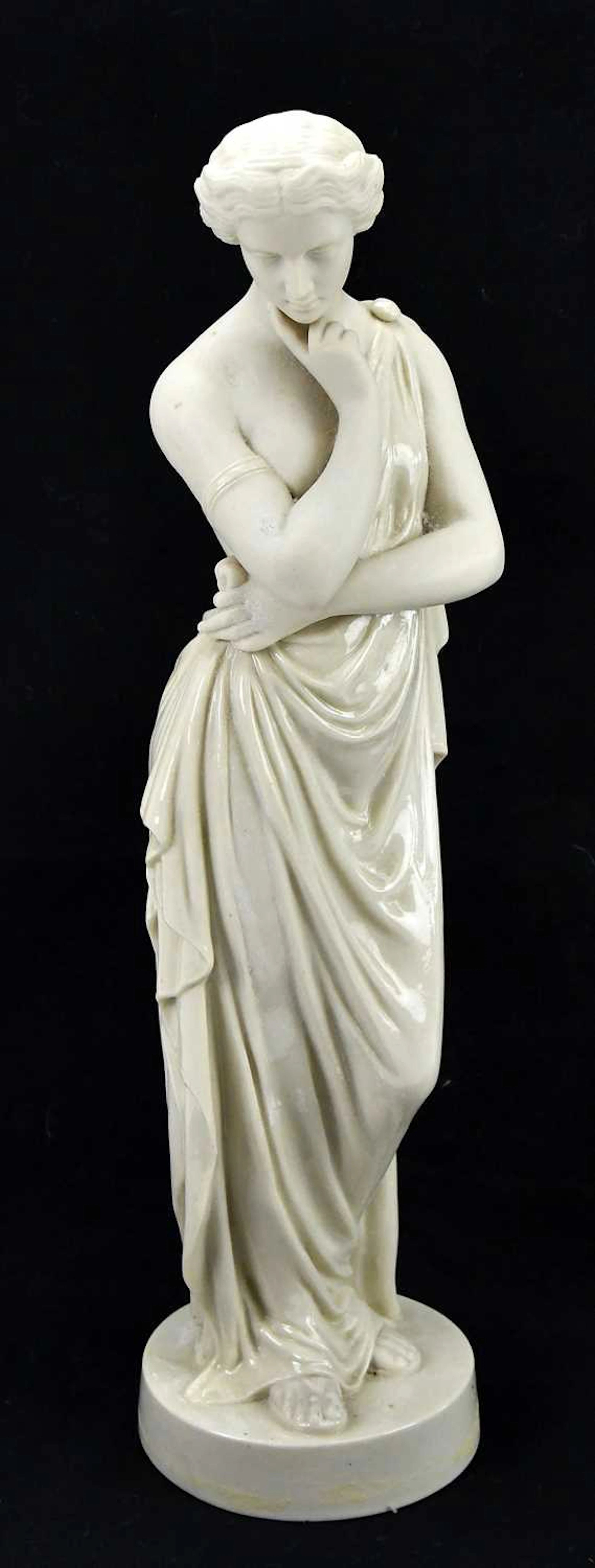 IN THE MANNER OF BELLEEK; a porcelain figure of a maiden