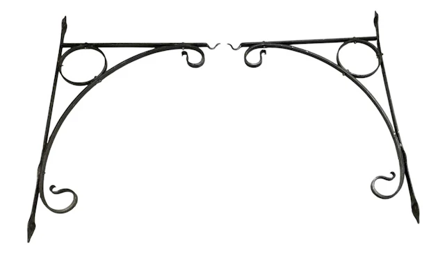 A pair of Victorian black painted cast iron wall hanging brackets