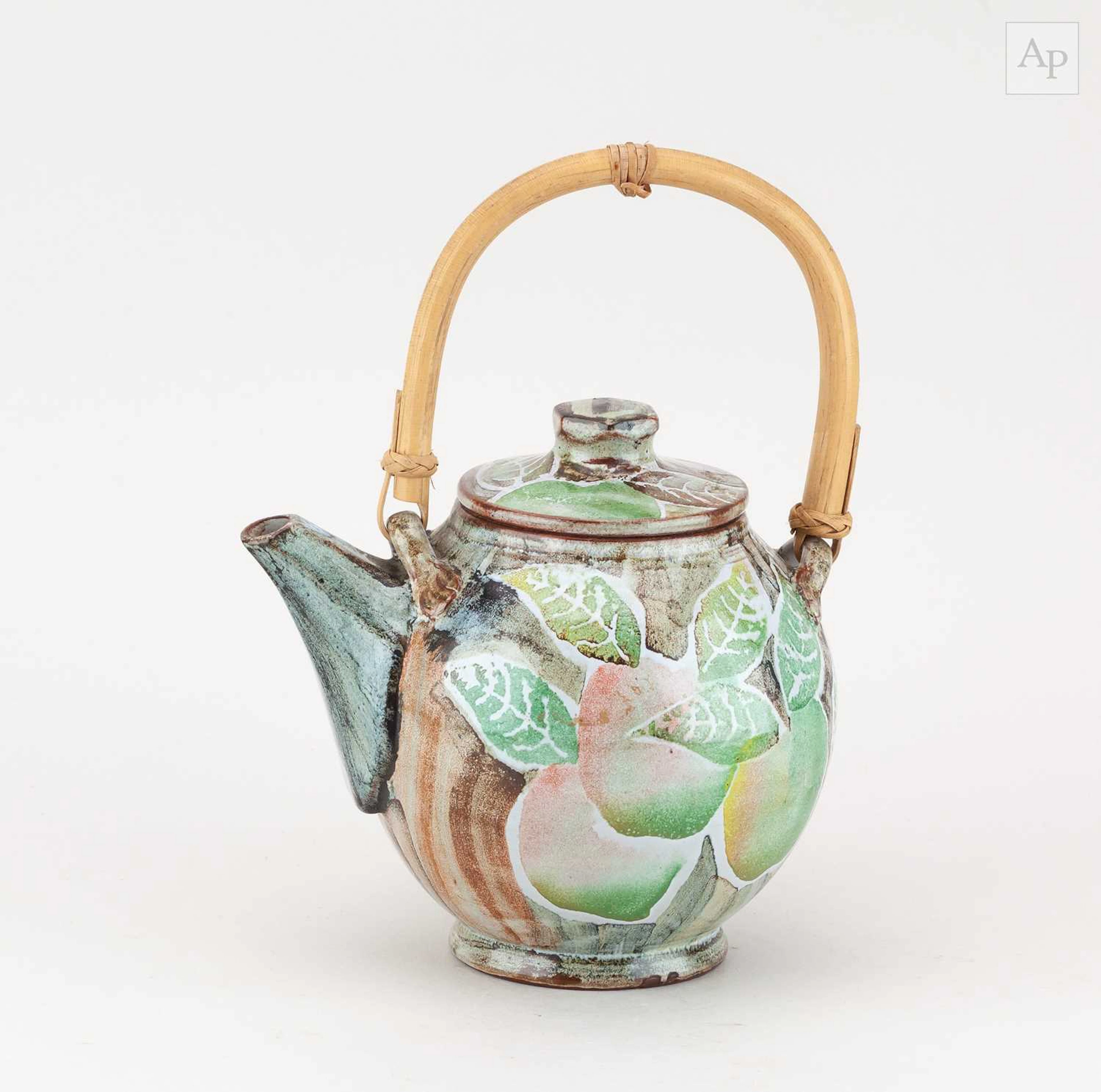ROB BIBBY; a tin glazed Maiolica style teapot with cane...