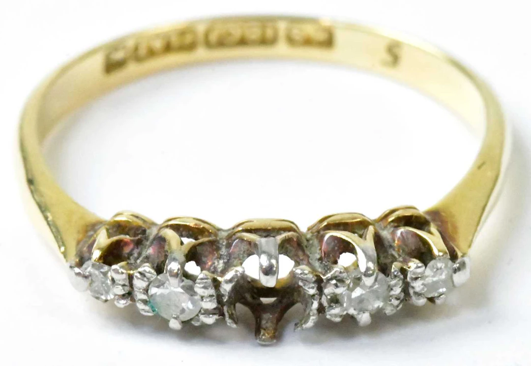 An 18ct yellow gold and platinum ring set with four...