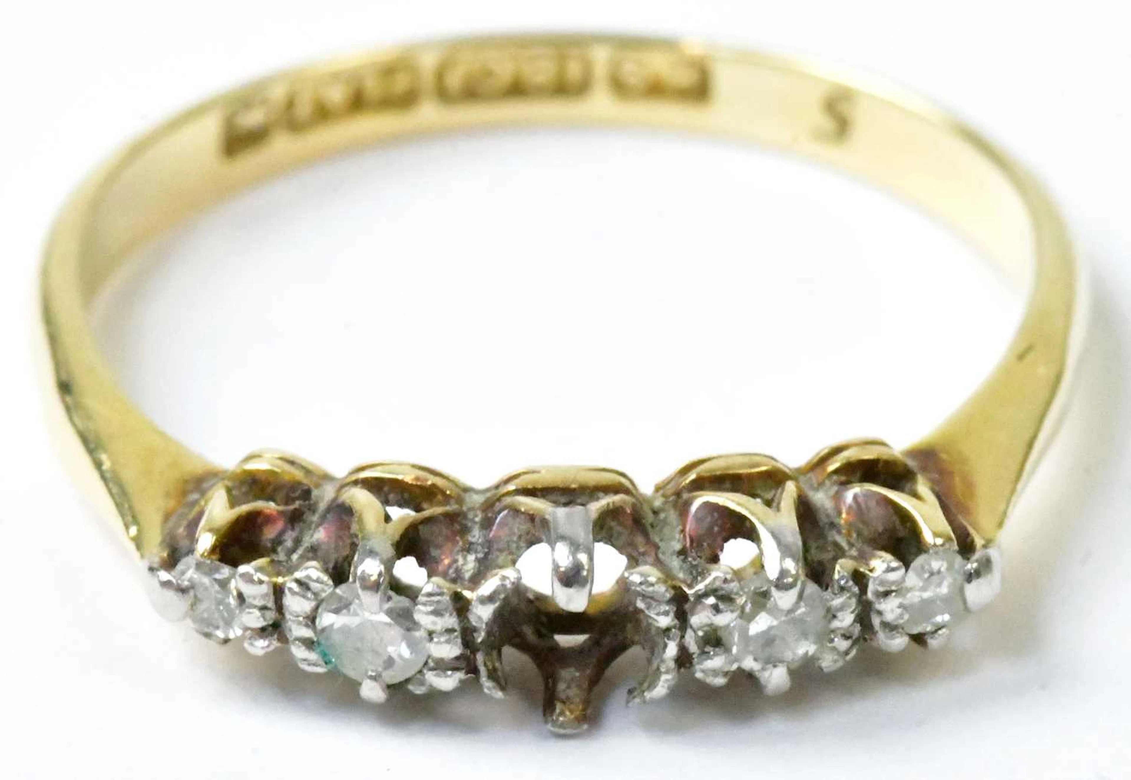 An 18ct yellow gold and platinum ring set with four...