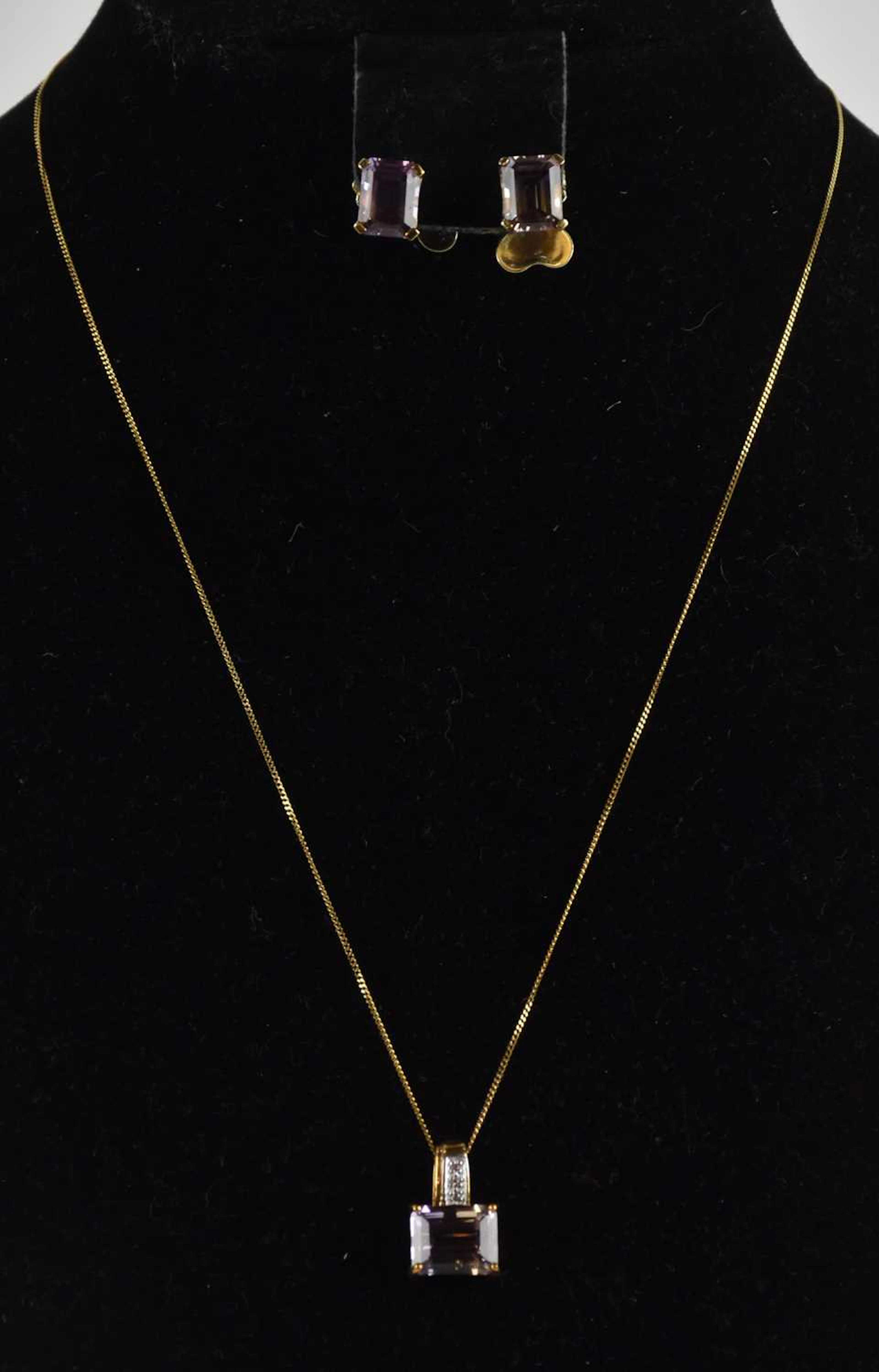 A claw set ametrine in a 9ct gold pendant mount embellished with tiny diamonds