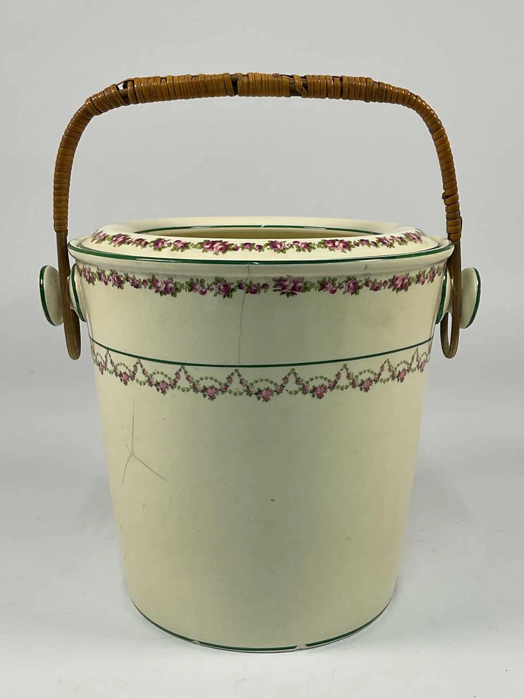 An Edwardian ceramic pail bucket with wicker handle and a floral garland border