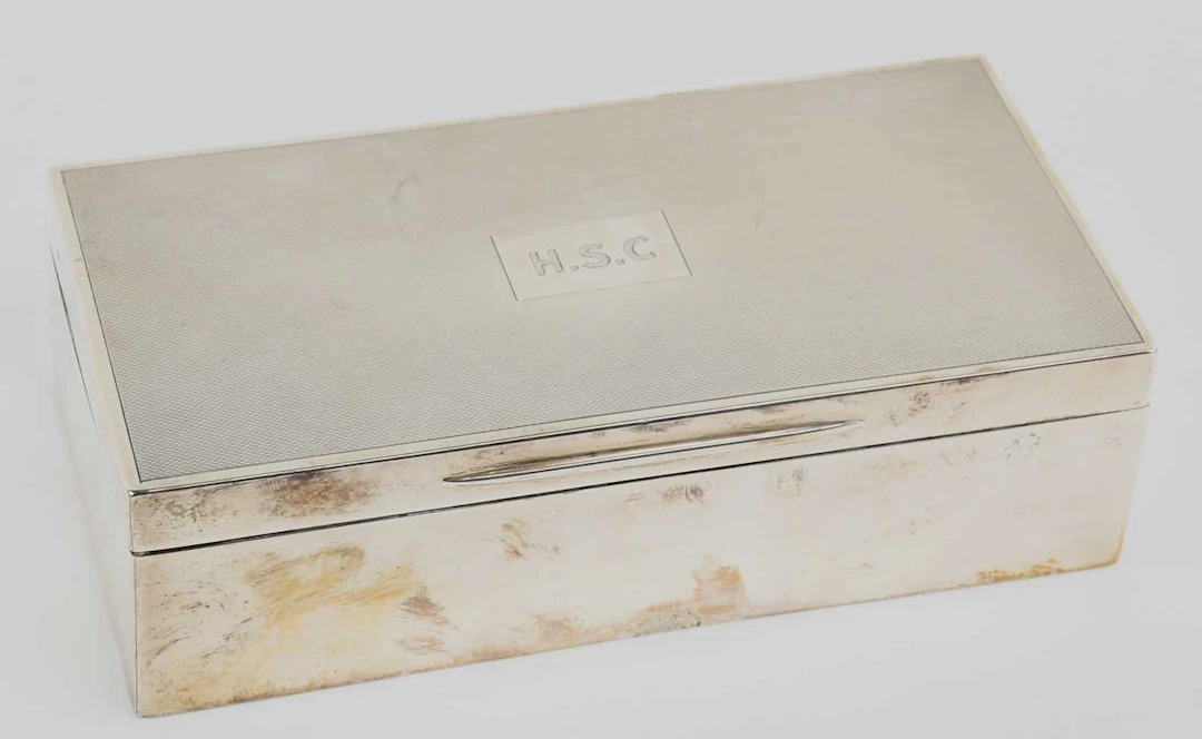 An early 20th century rectangular wood lined hallmarked silver cigarette box