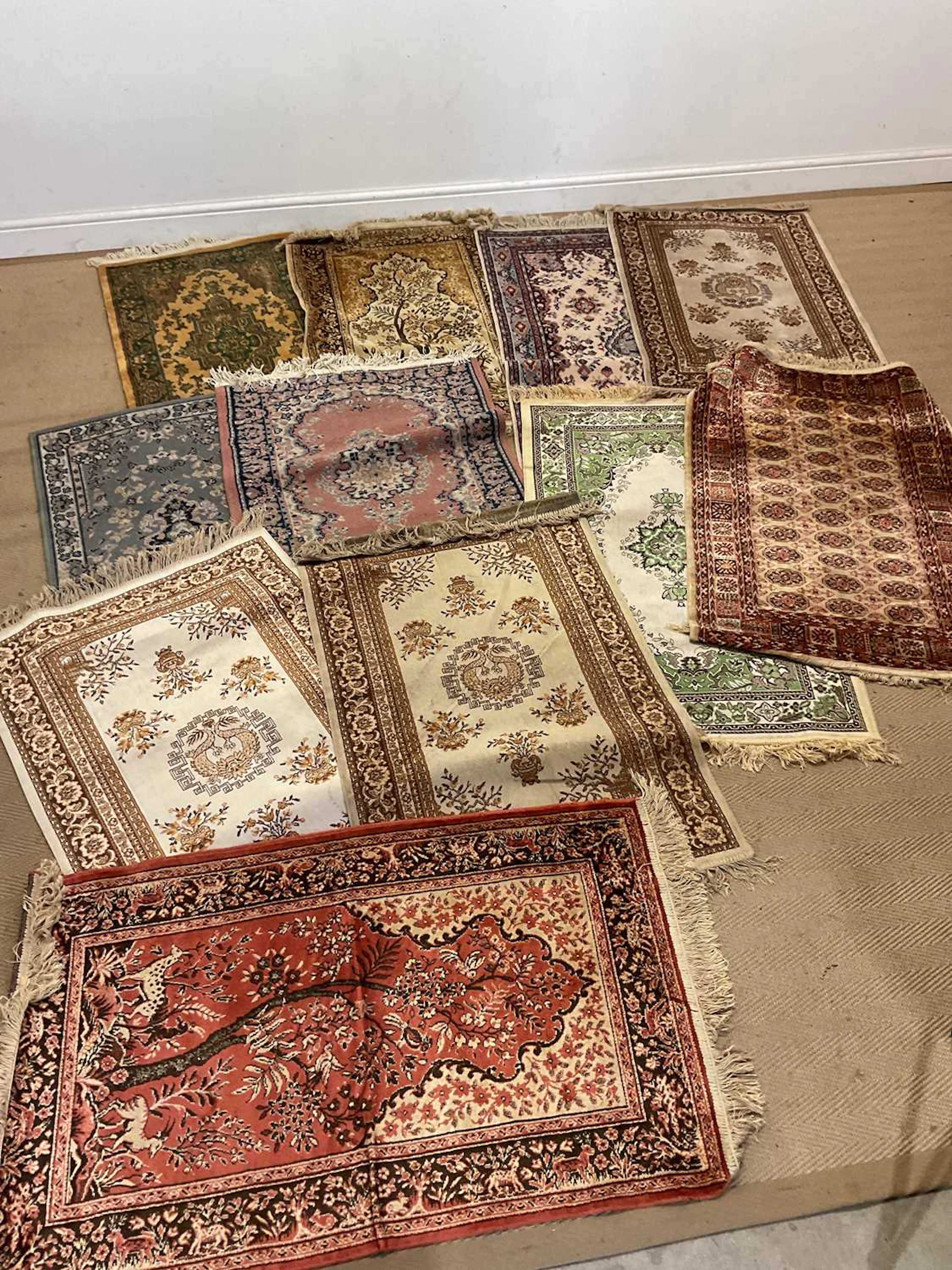 Eleven machine woven small rugs