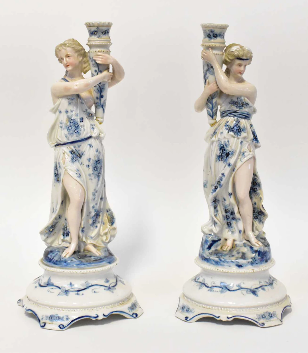 A pair of Meissen-style 19th century Continental porcelain figural candlesticks