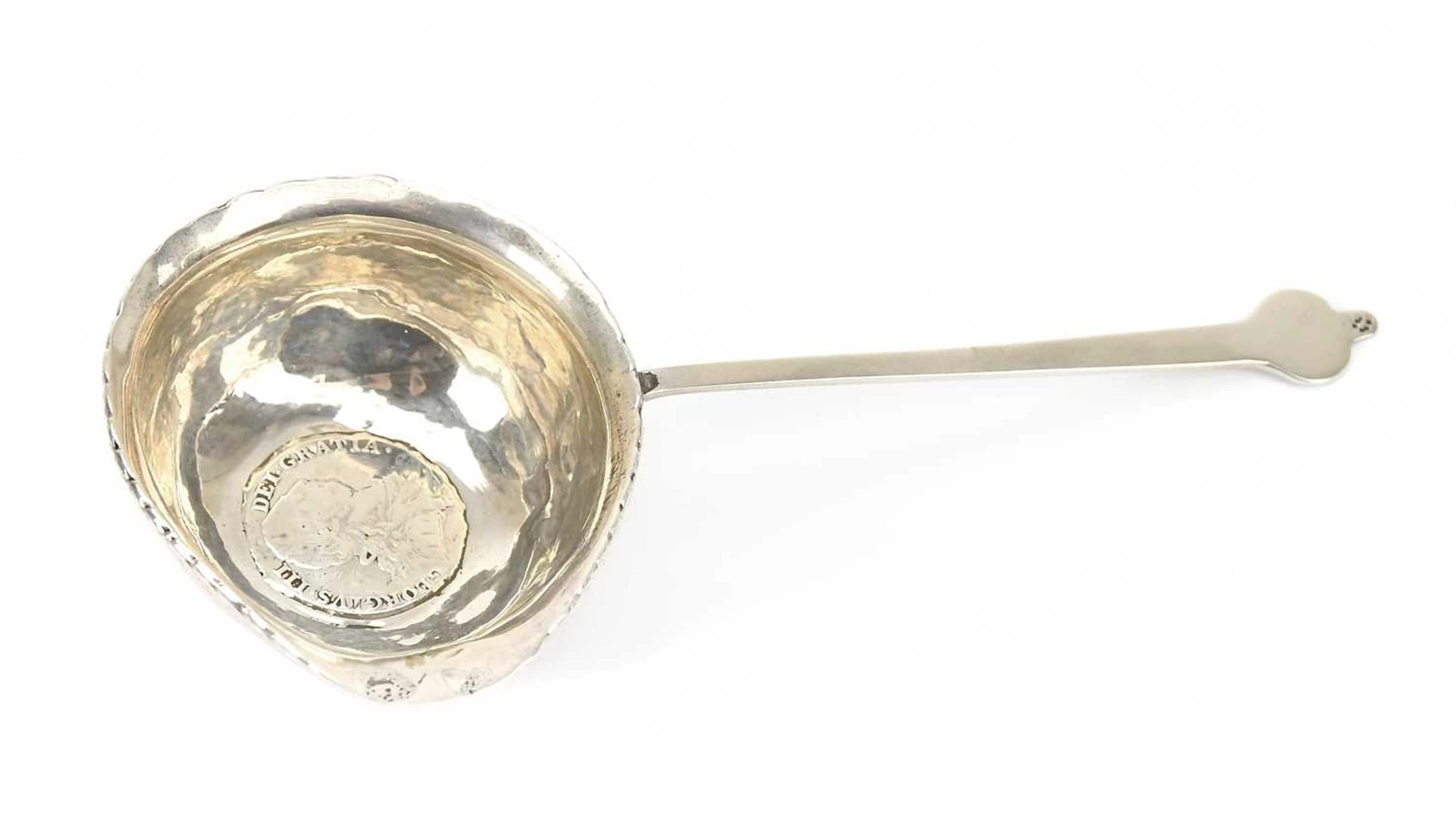 A white metal brandy warmer