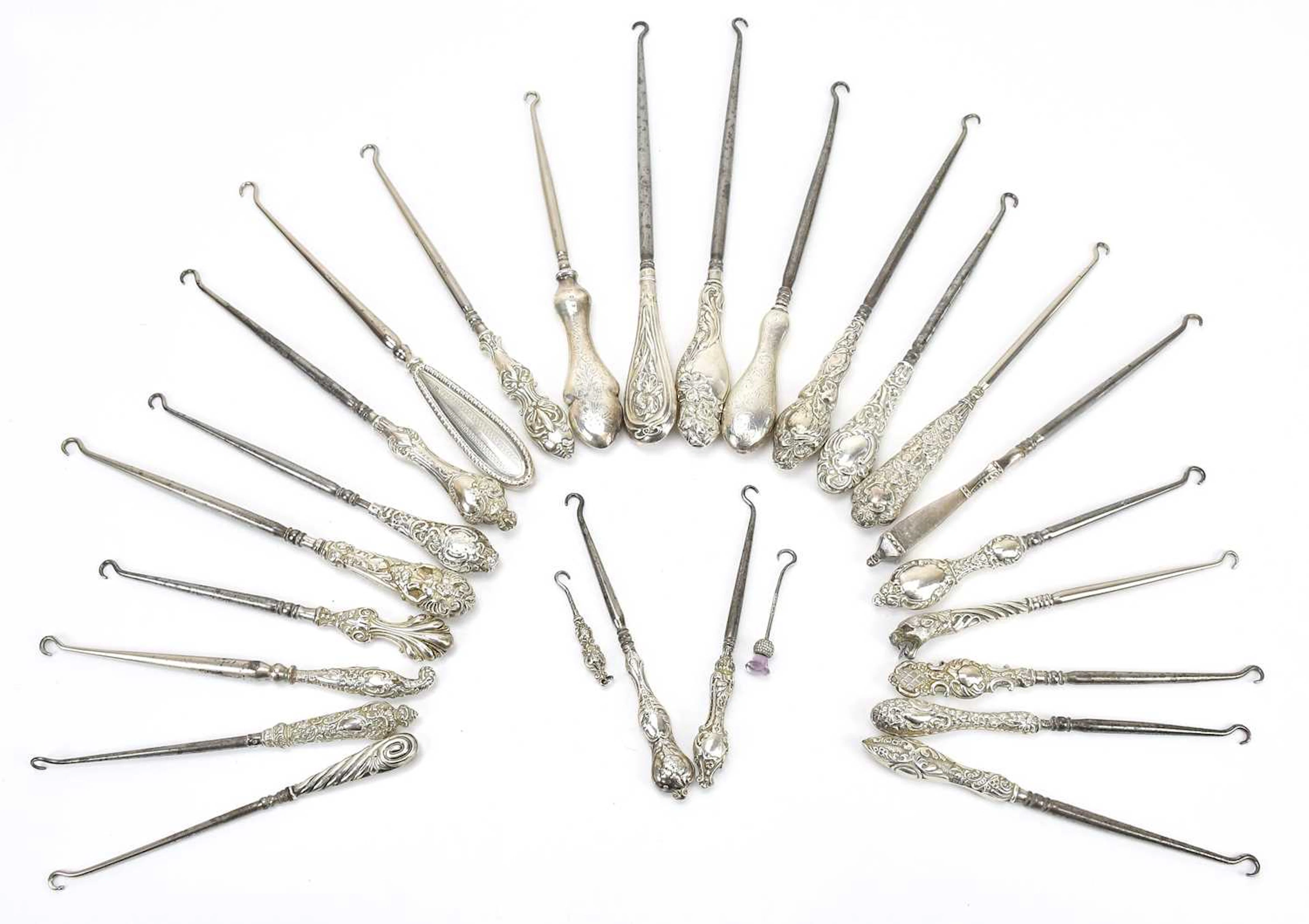 A collection of hallmarked silver mounted button hooks