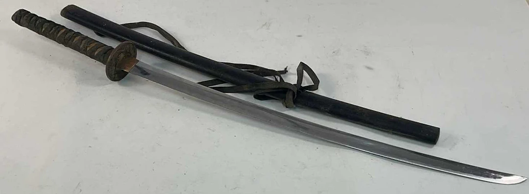 A Katana style sword in plain wooden sheath