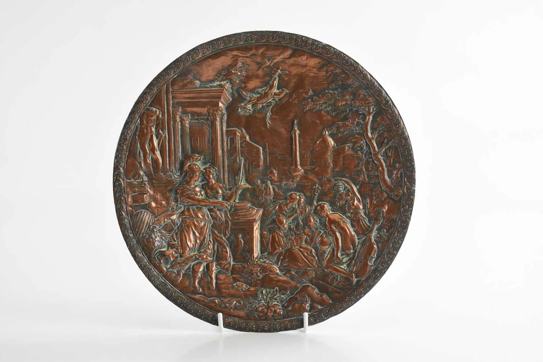 AFTER HANS JAKOB BAYER; an embossed copper circular wall plaque