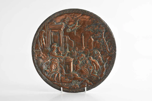 AFTER HANS JAKOB BAYER; an embossed copper circular wall plaque
