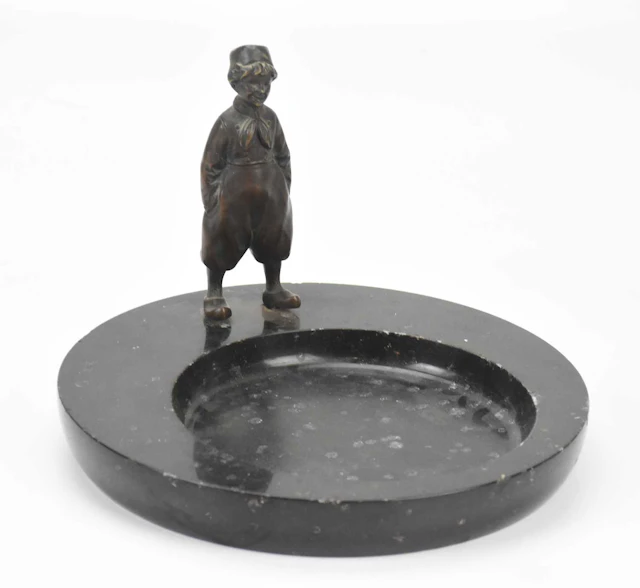 An Art Deco bronze figural bowl representing a Dutch boy wearing clogs