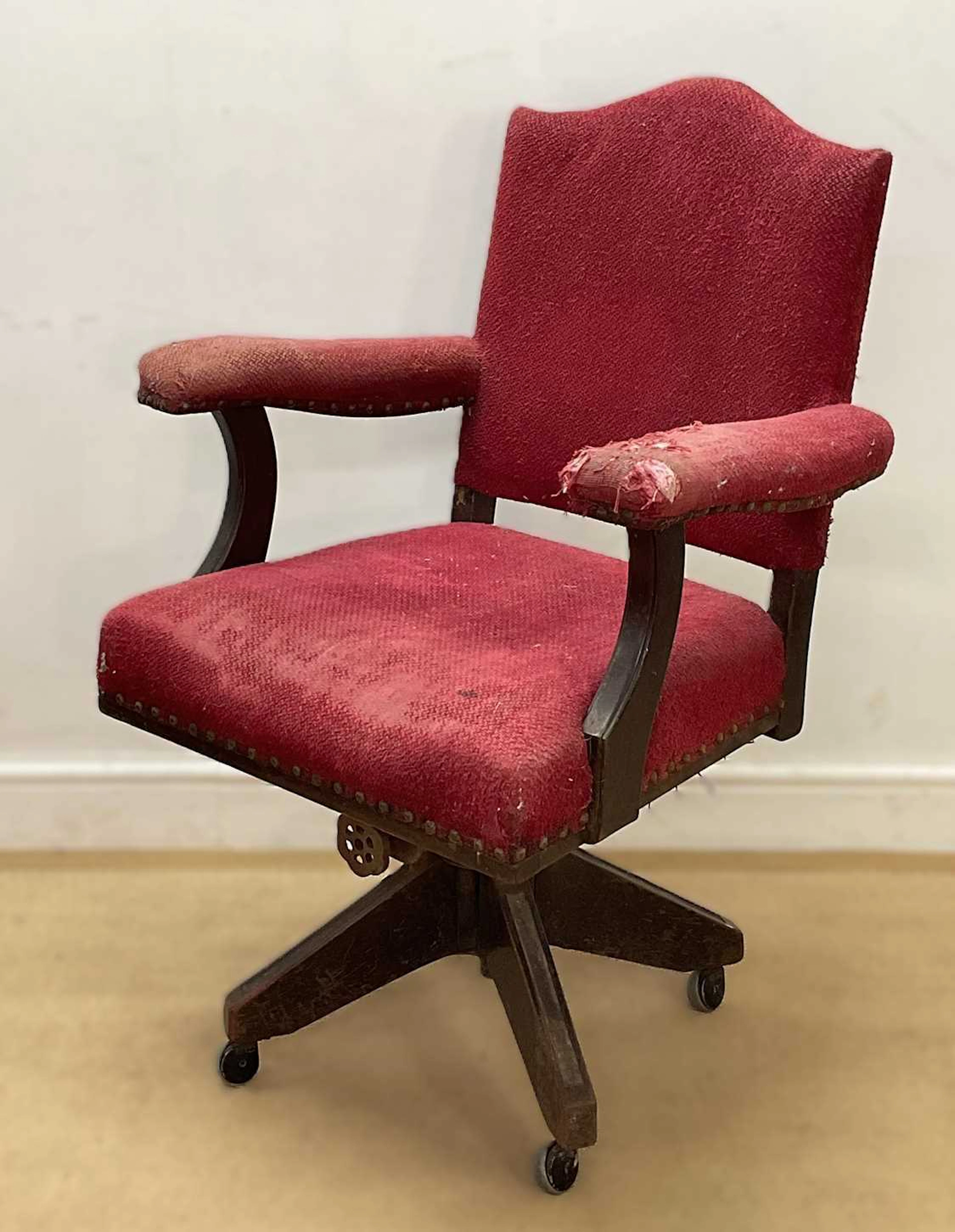 An early 20th century swivel office armchair oak frame...