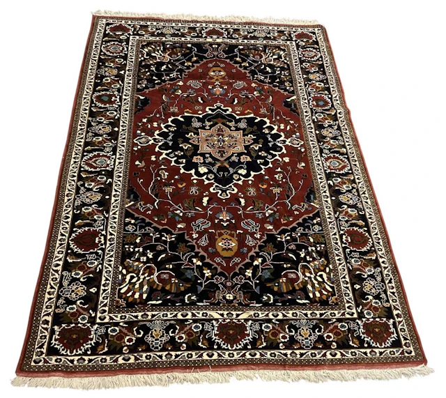 A Northeast Persian woollen red and blue ground rug