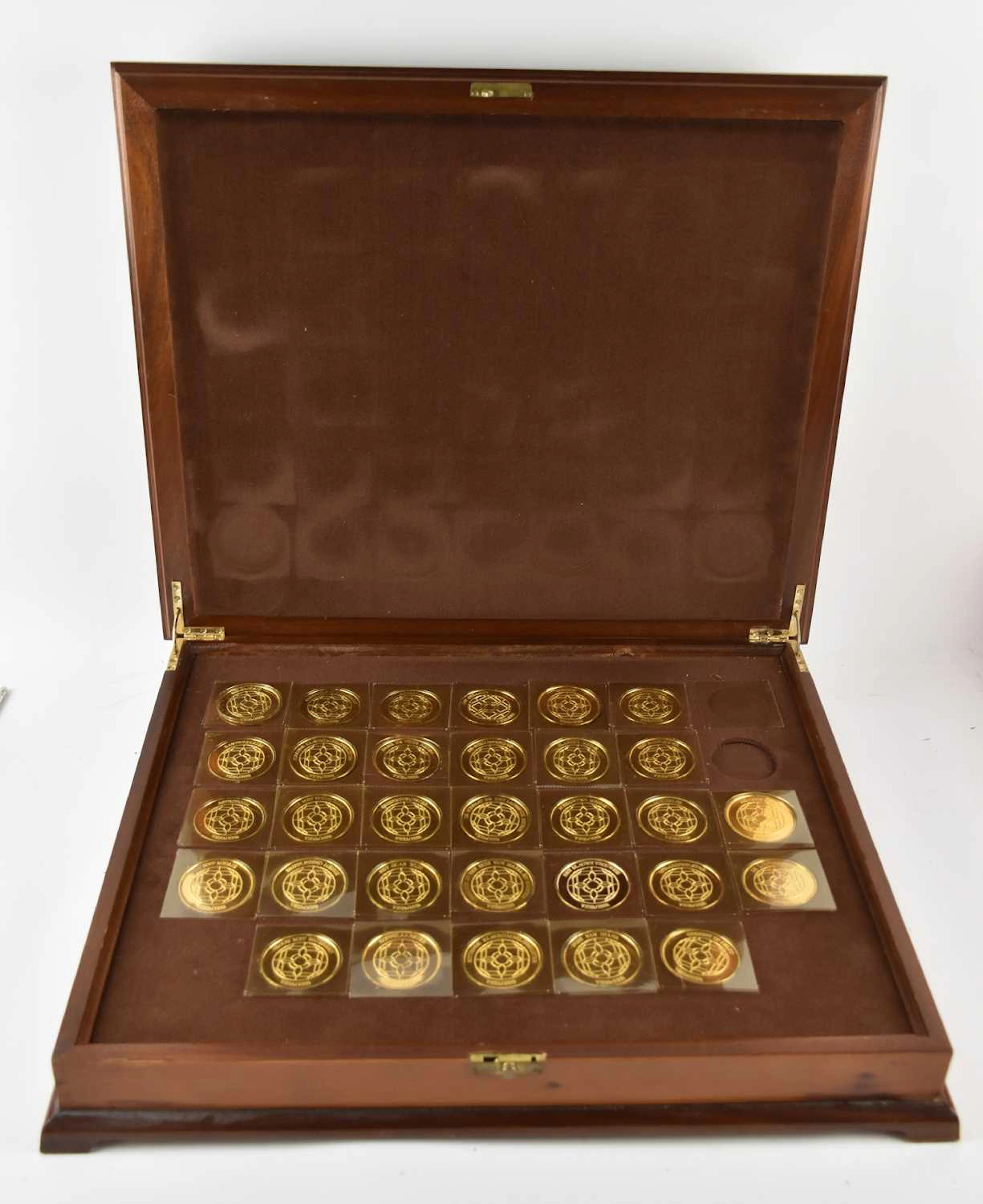 JOHN PINCHES LTD; a cased set of thirty-two 925 silver gilt medallions