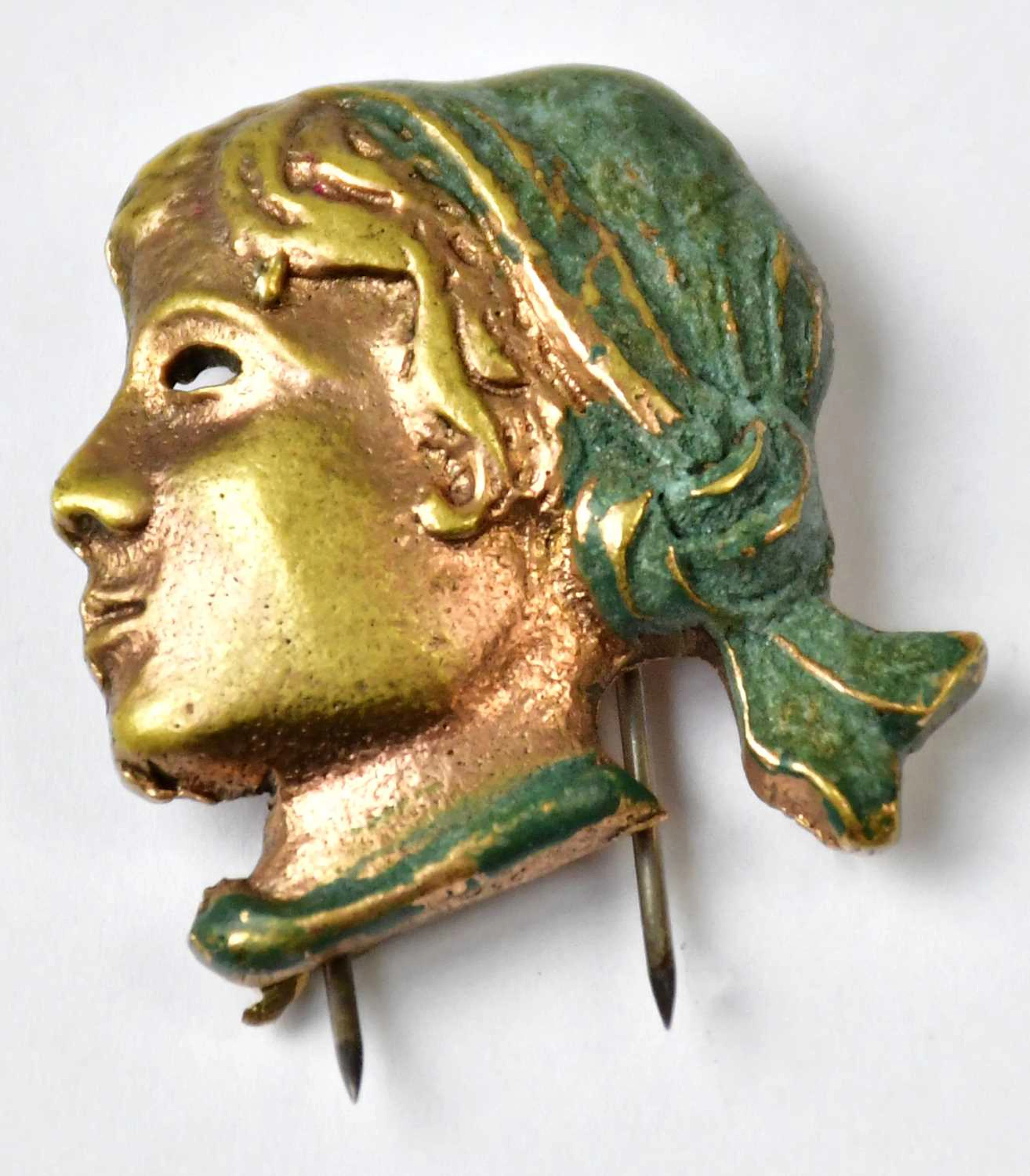 A vintage brooch in the form of a girl's head