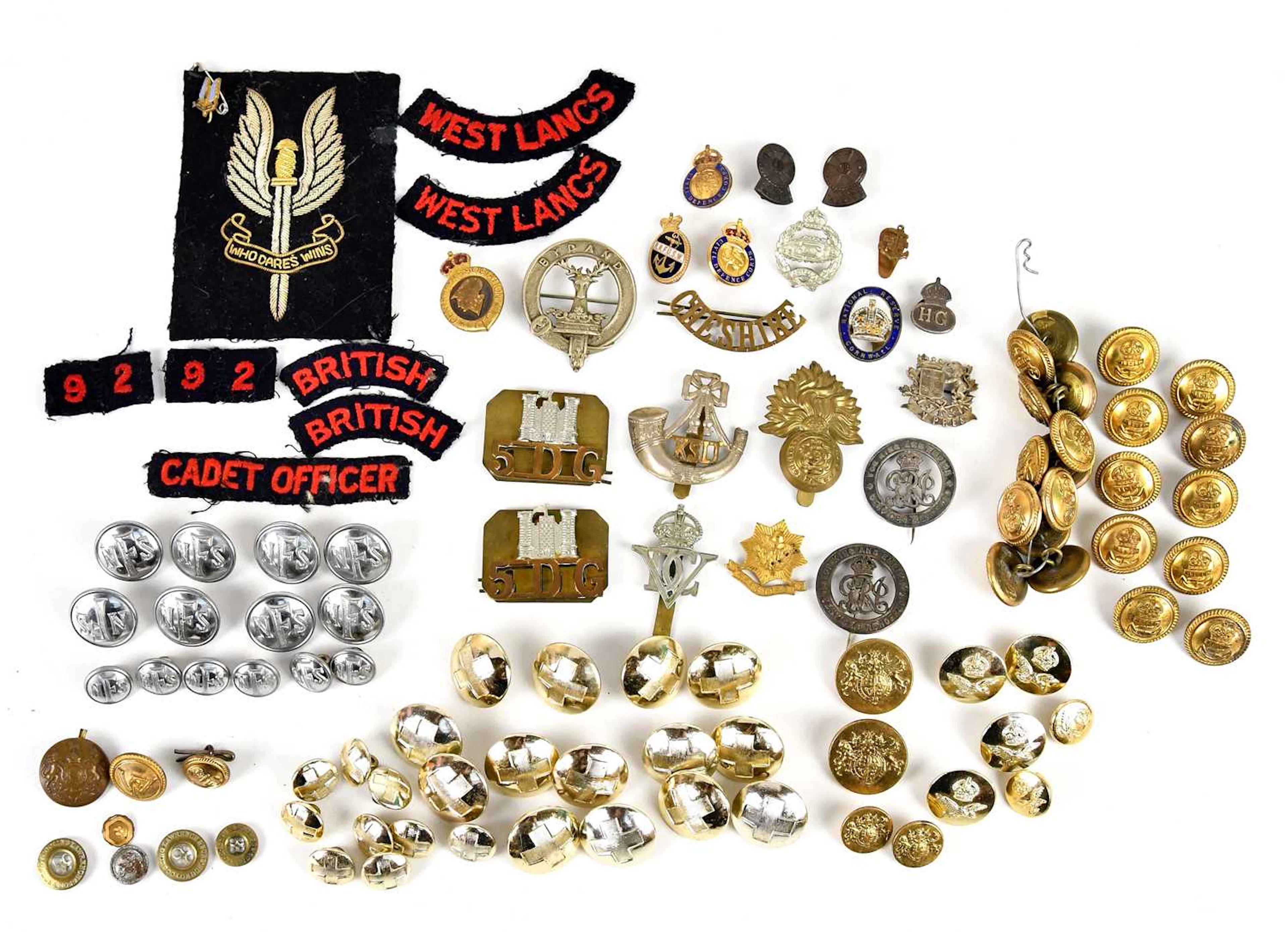A collection of British Military and Home Front insignia comprising cap badges