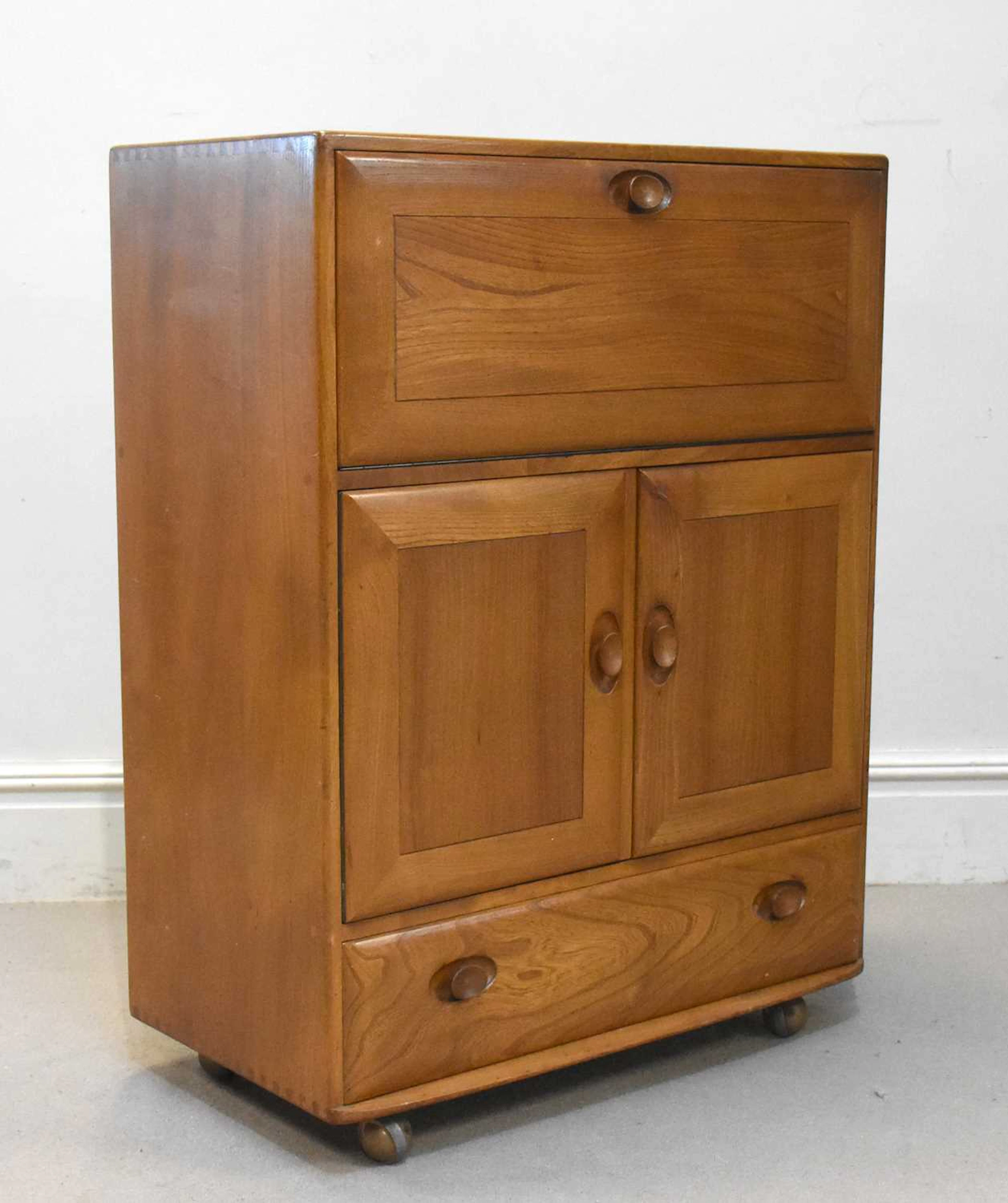 ERCOL; a medium elm cocktail/drinks cabinet
