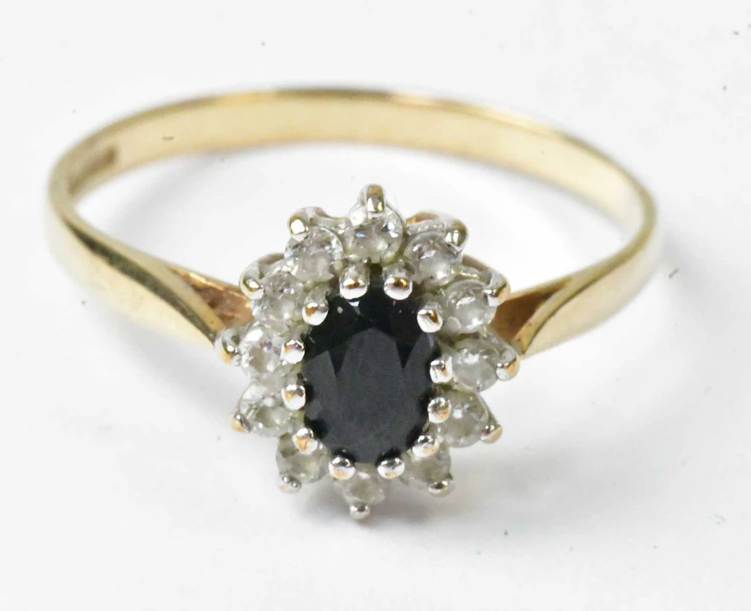 A 9ct yellow gold cluster ring set with a central...