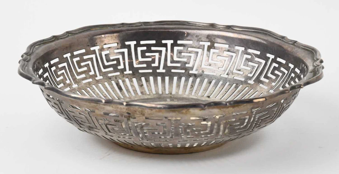 A George V hallmarked silver circular pierced bonbon dish