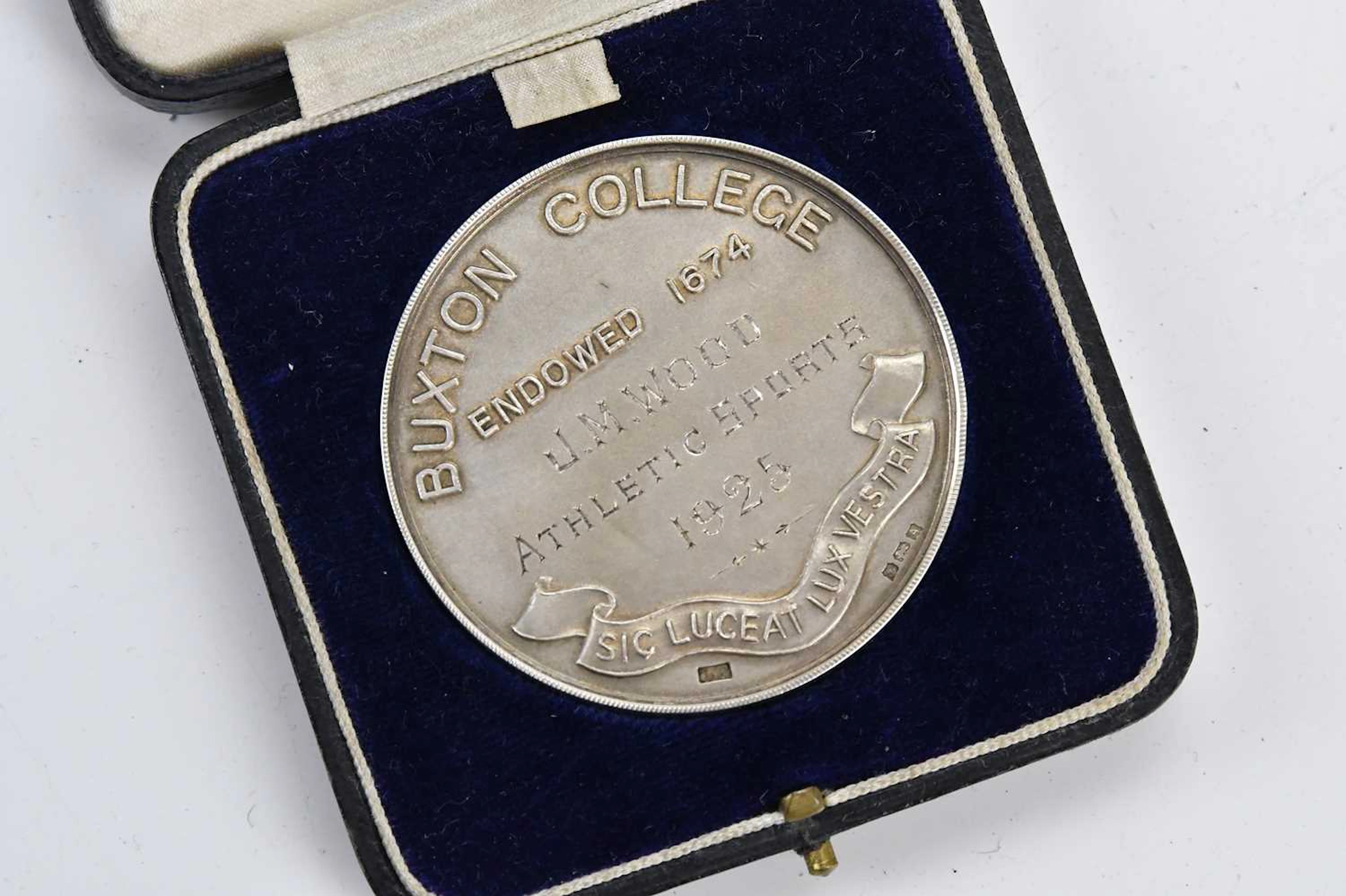 A cased hallmarked silver medal awarded at Buxton College...