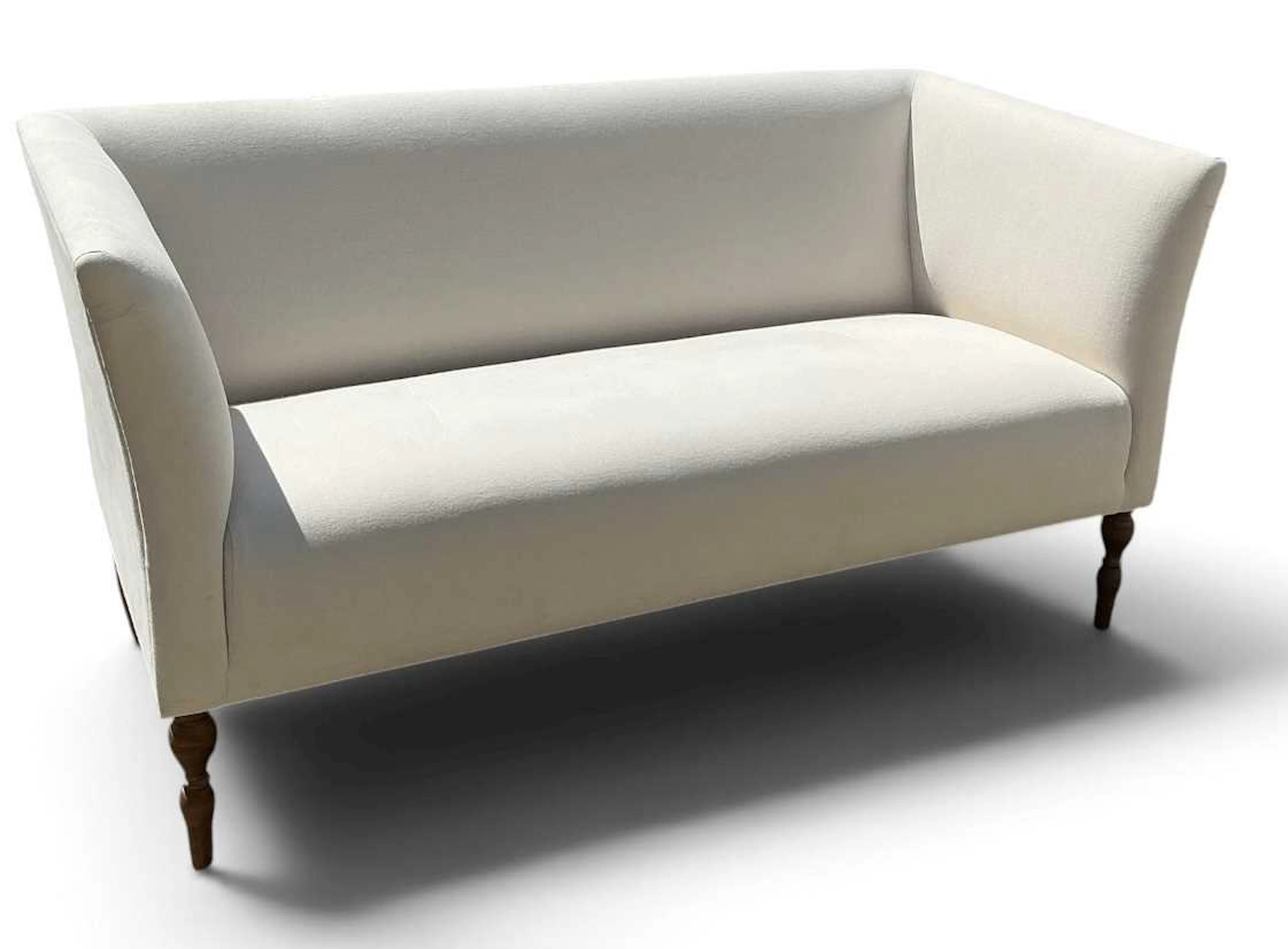 A modern contemporary white upholstered two seater sofa