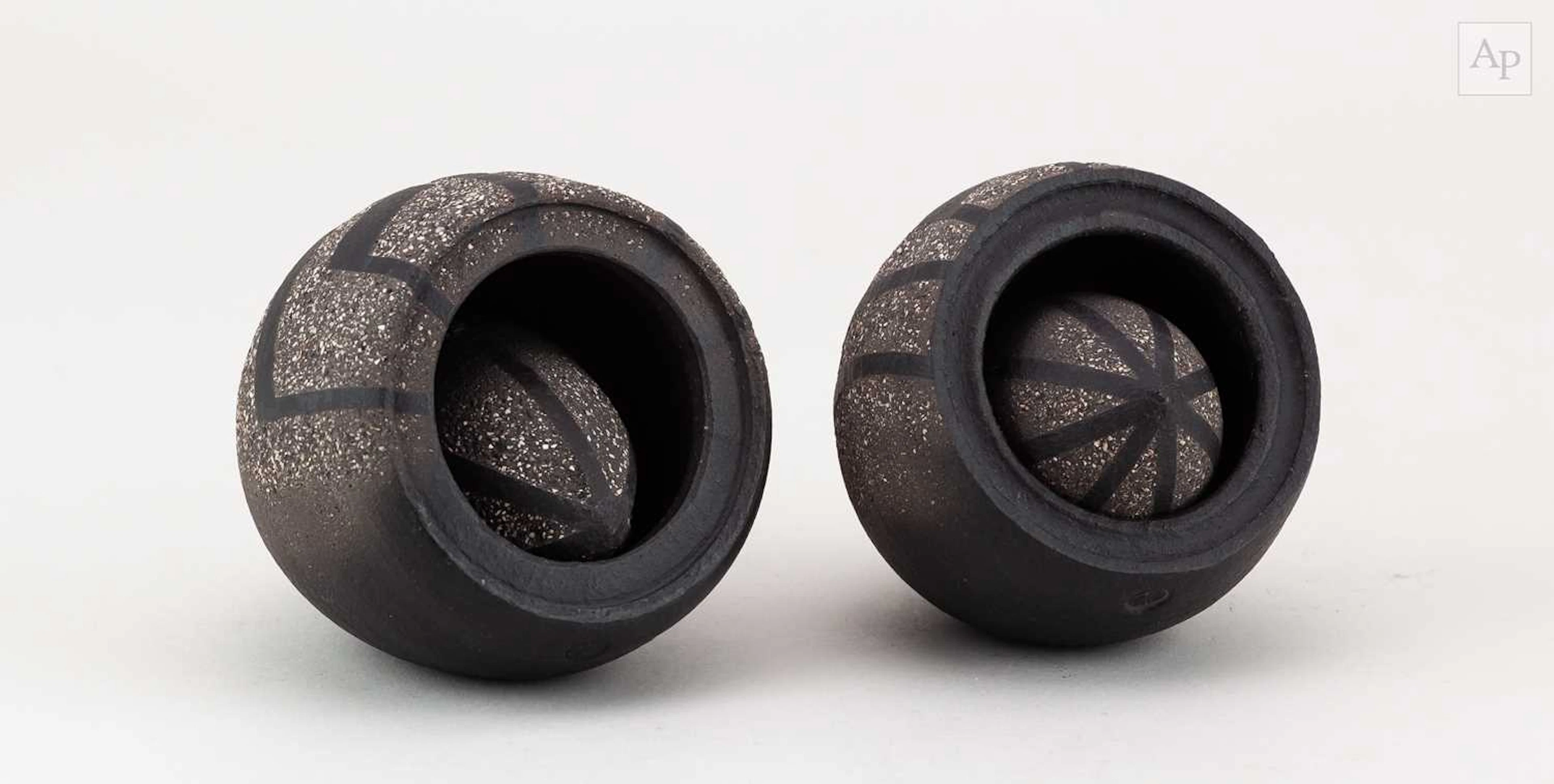 ERIC MOSS (born 1959); a pair of grogged black stoneware...