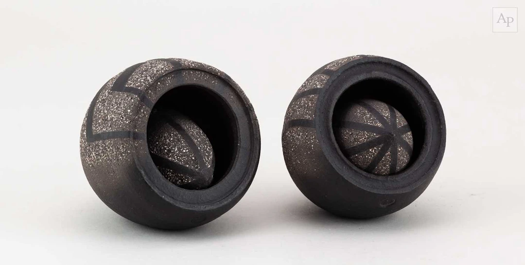ERIC MOSS (born 1959); a pair of grogged black stoneware...