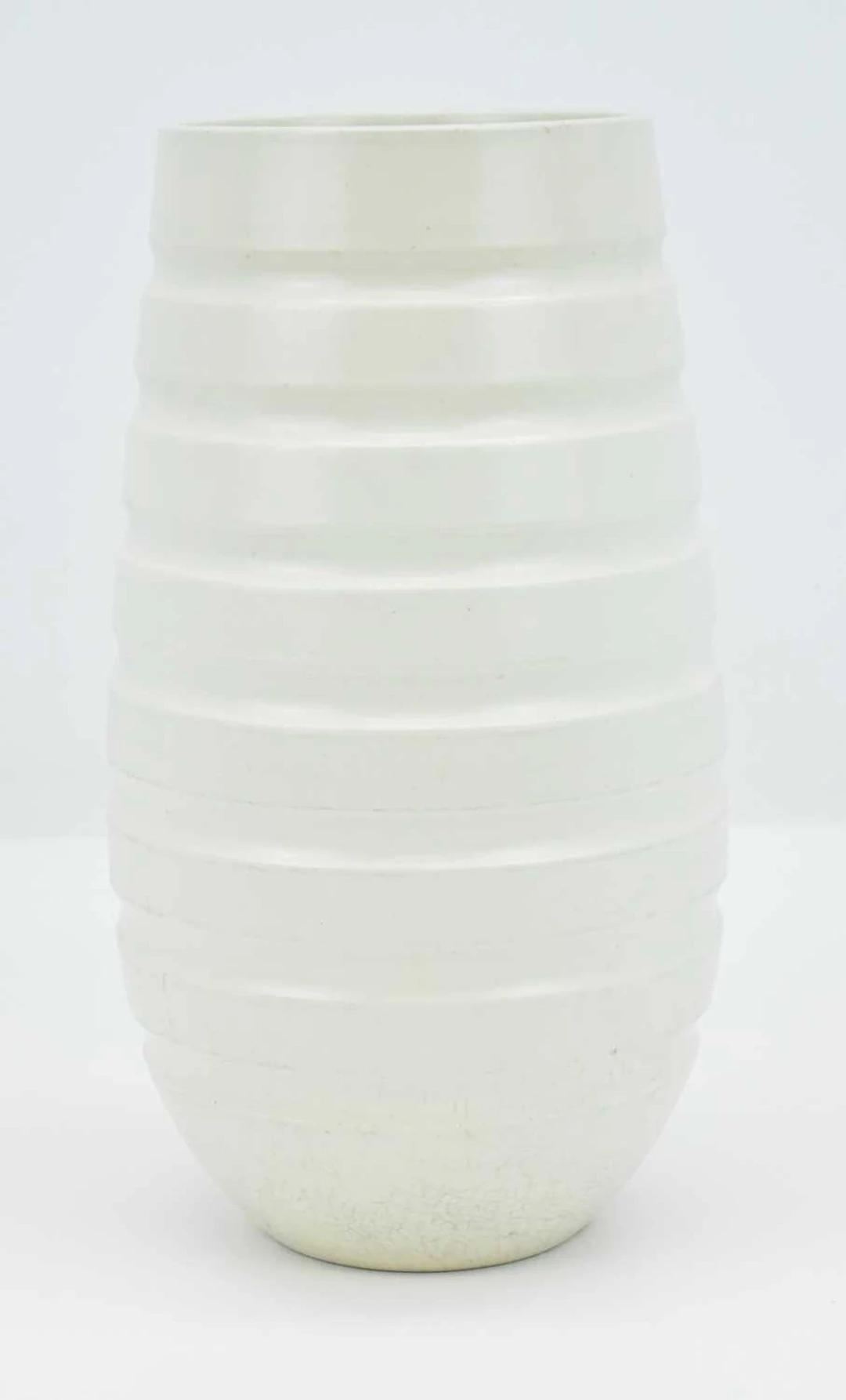 KEITH MURRAY FOR WEDGWOOD; a 1930s Art Deco white tapered...