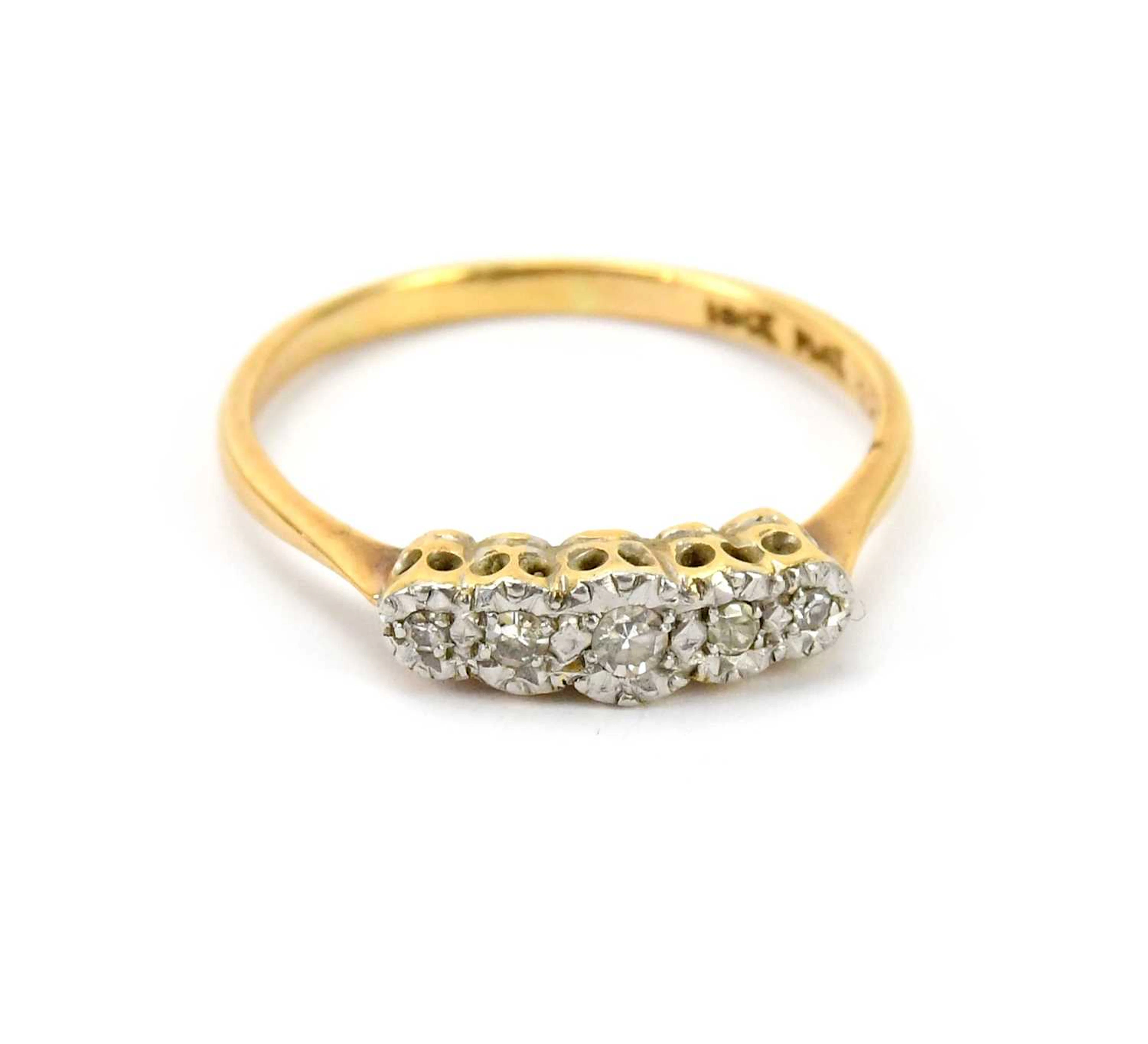 An 18ct gold and platinum five stone diamond set dress ring