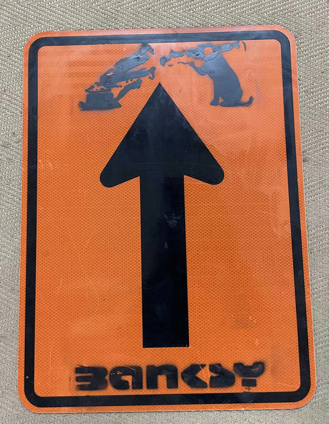 IN THE MANNER OF BANKSY; a aluminum sign with Banksy at...