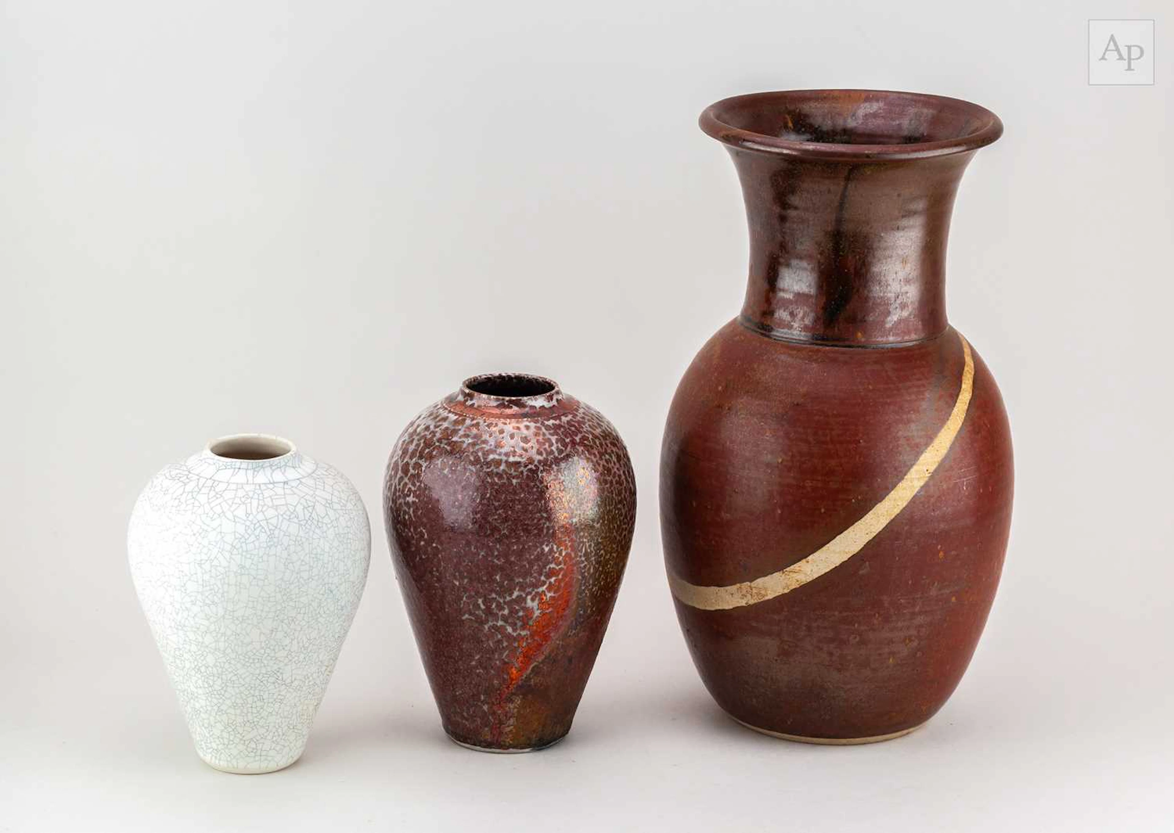 BRUCE CHIVERS (born 1954); a raku vase covered in crawling copper red glaze