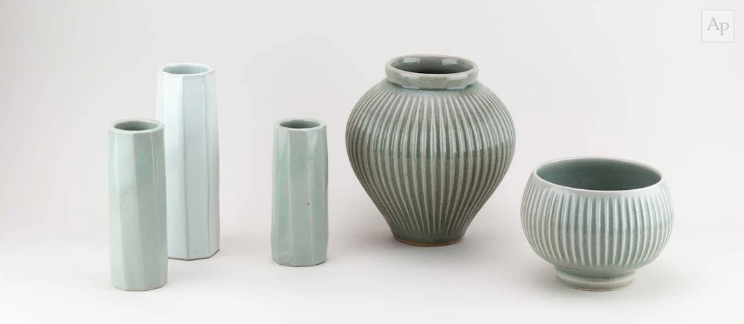 ANDREW CROUCH (born 1955); a fluted stoneware jar covered in green ash glaze