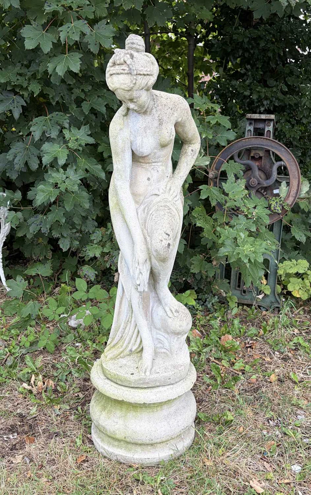 A reconstituted stone garden statue of a maiden