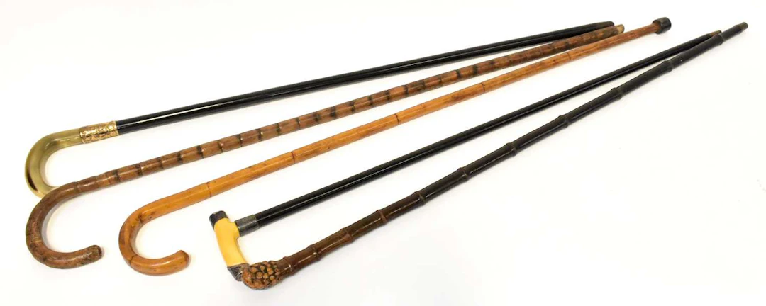 Five Victorian and later walking sticks/canes comprising...