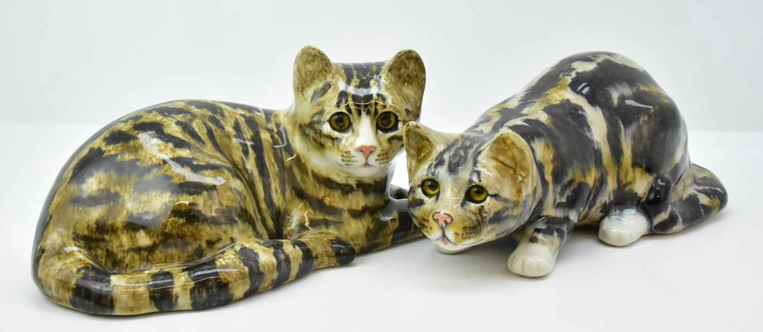 WINSTANLEY; two large pottery figures of tabby cats with glass eyes