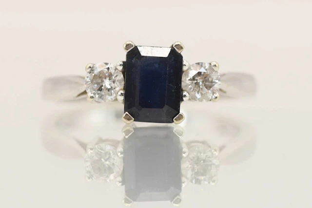 An 18ct white gold sapphire and diamond set three stone ring