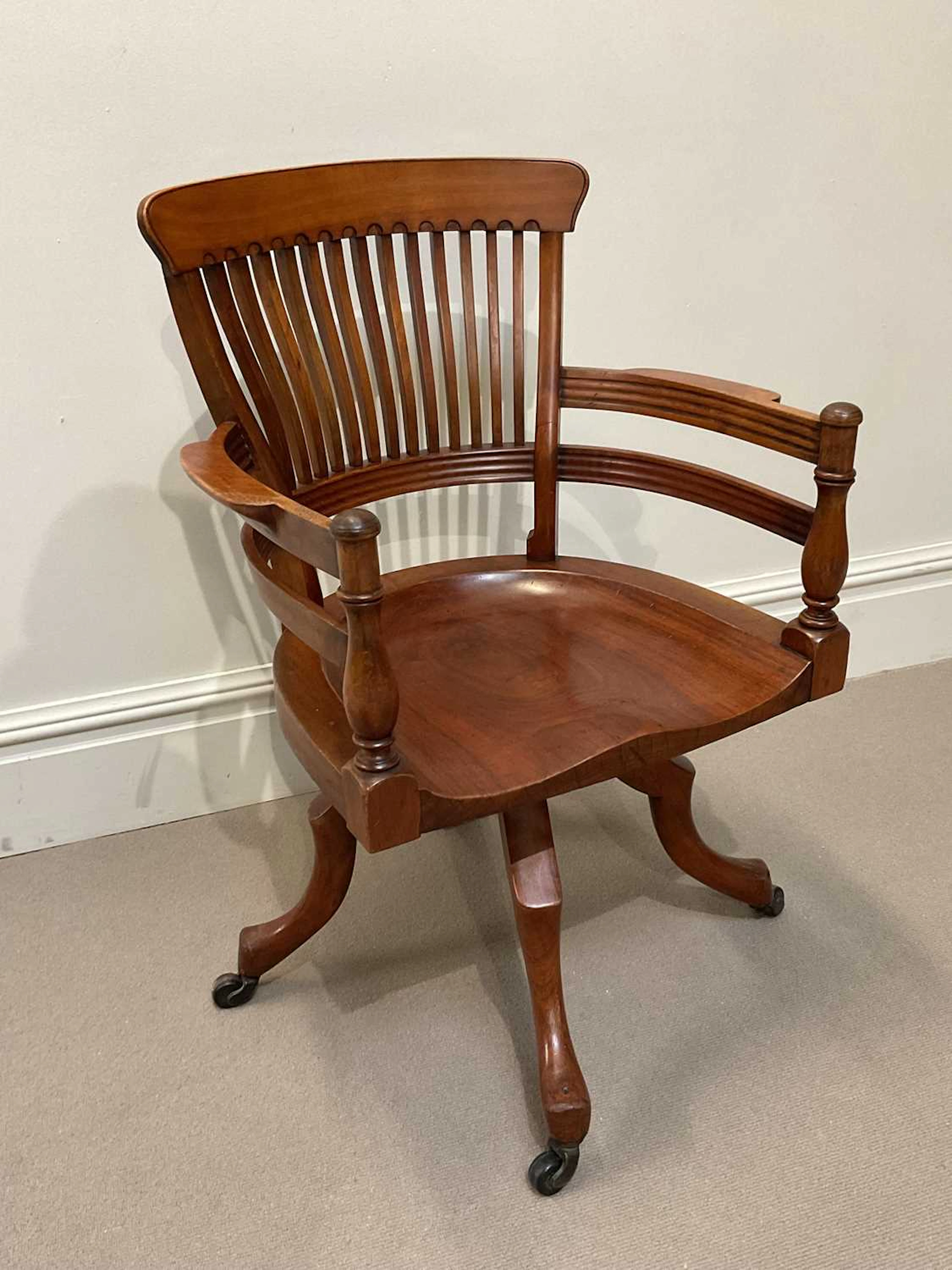 AFTER E W GODWIN; a late 19th century walnut swivel desk...