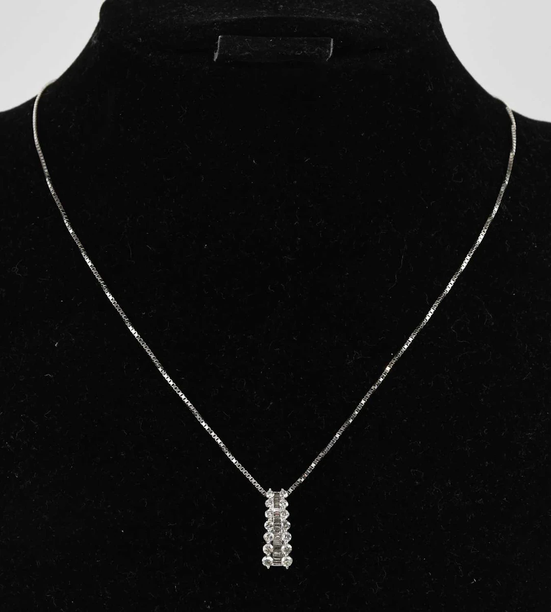 A 14ct white gold diamond set drop pendant