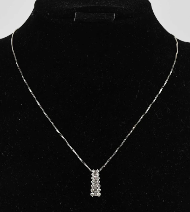 A 14ct white gold diamond set drop pendant
