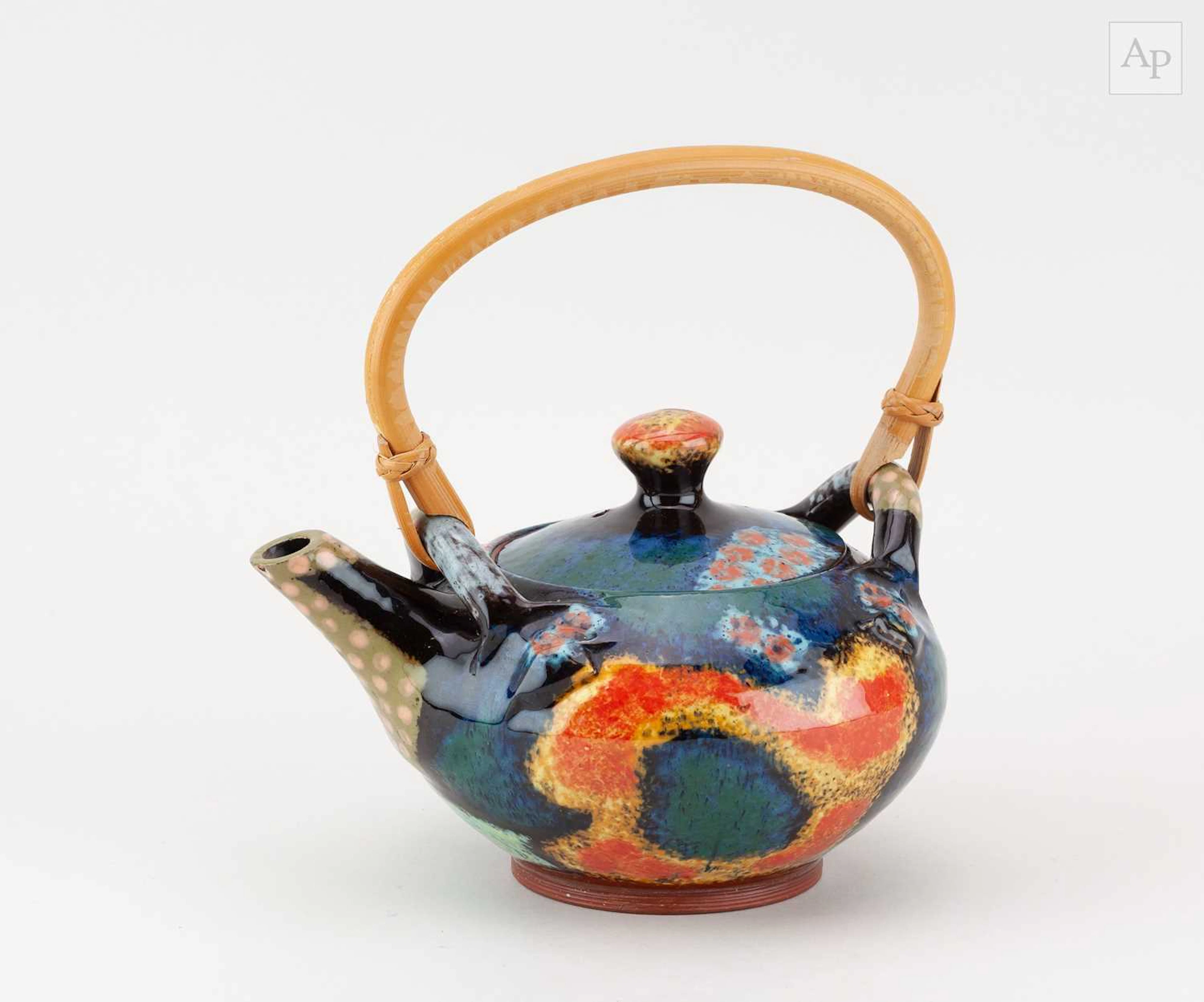 JOHN POLLEX (born 1941); a slipware teapot with cane...