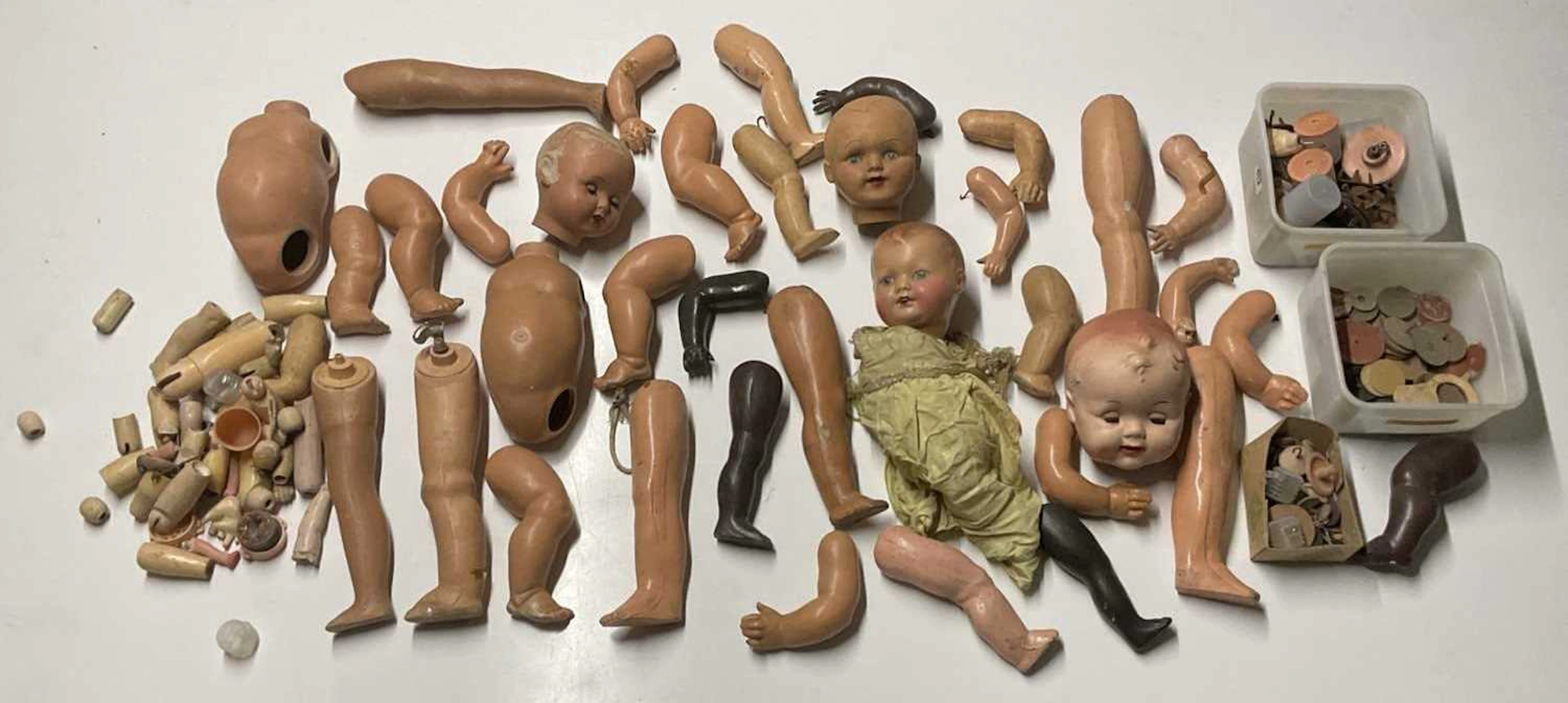 A large amount of vintage doll body parts