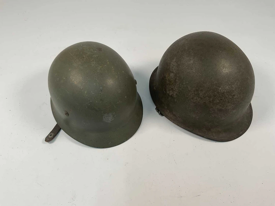 Two WWII era American helmets