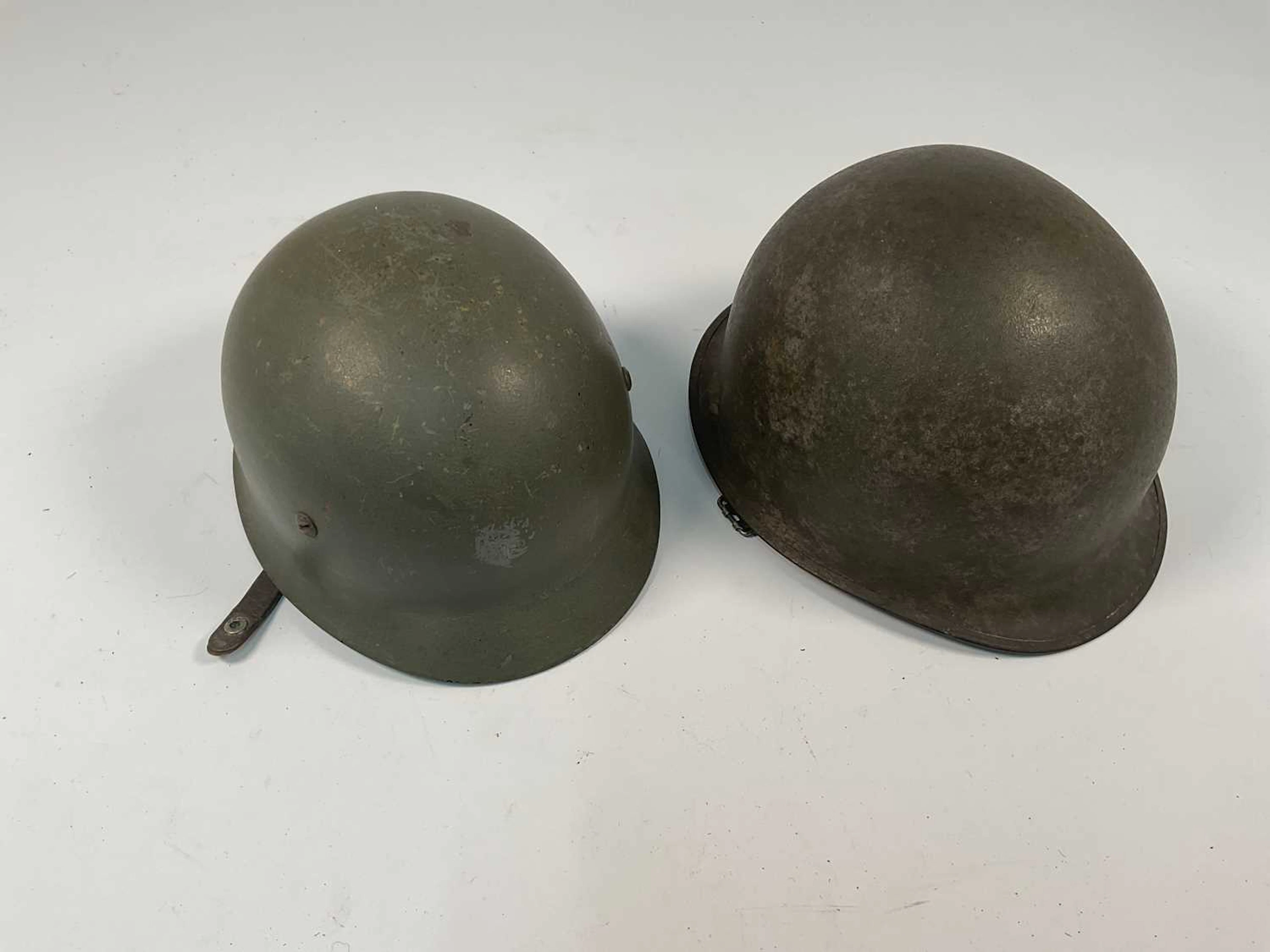 Two WWII era American helmets