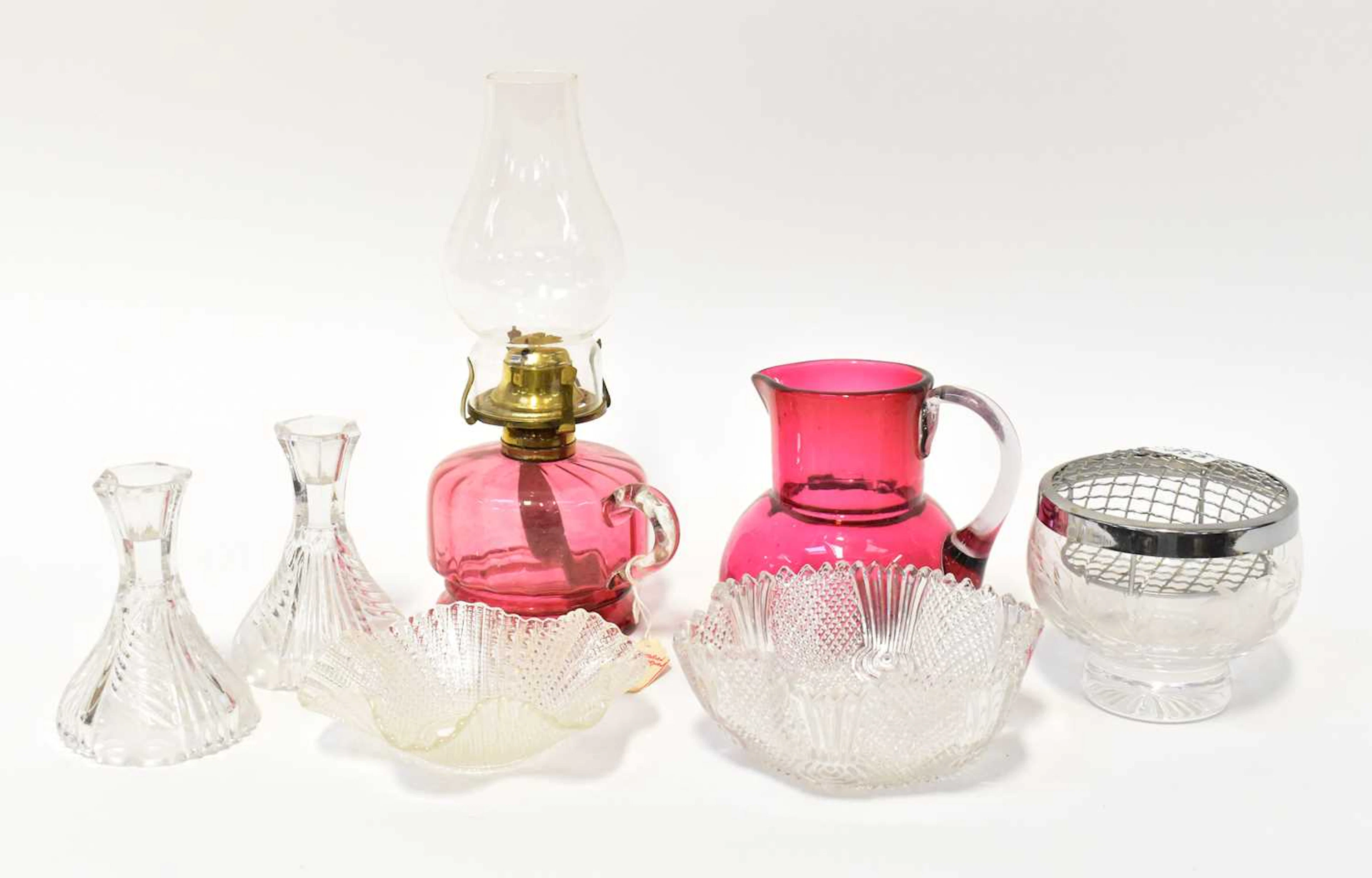 A Victorian cranberry glass oil lamp with brass fittings