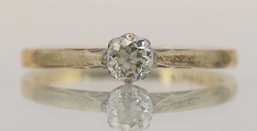 An 18ct yellow gold and platinum diamond solitaire ring