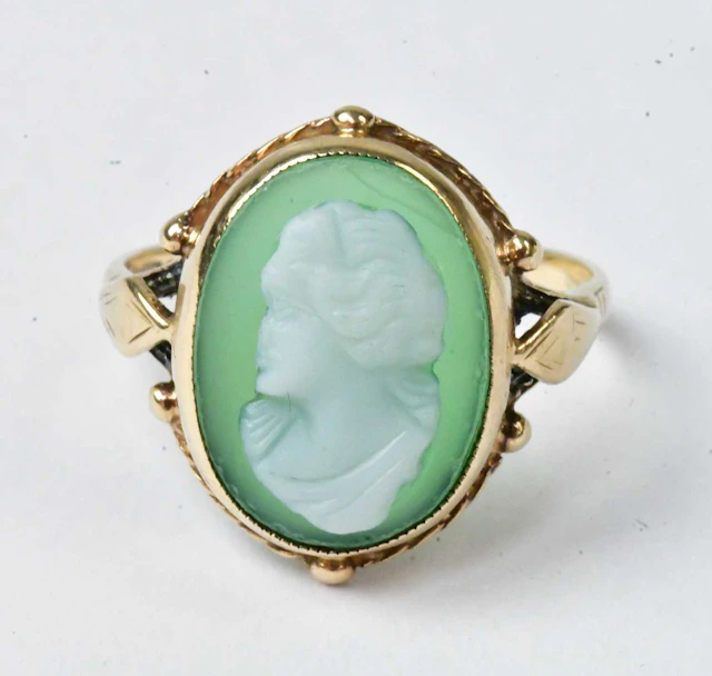 A 9ct yellow gold ring set with a green stone cameo