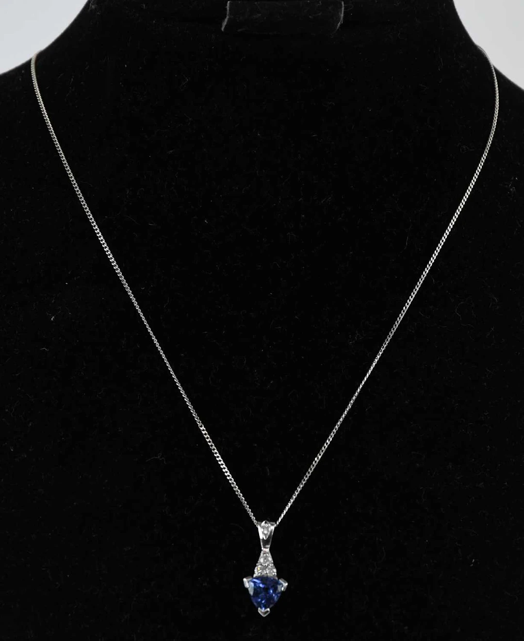 An 18ct white gold tanzanite and diamond set drop pendant