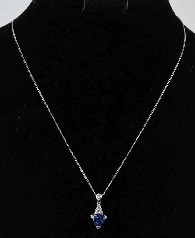 An 18ct white gold tanzanite and diamond set drop pendant